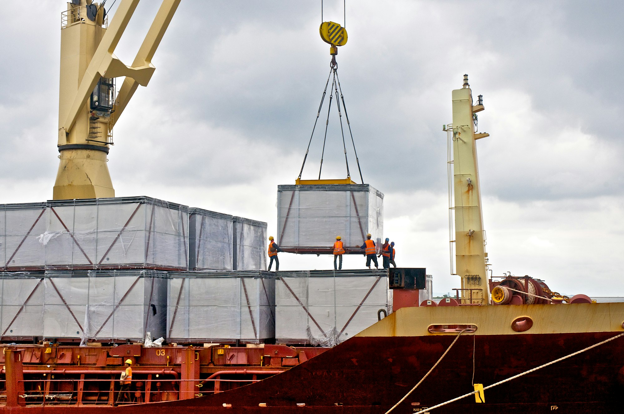 Loading cargo into the ship in port shipyard